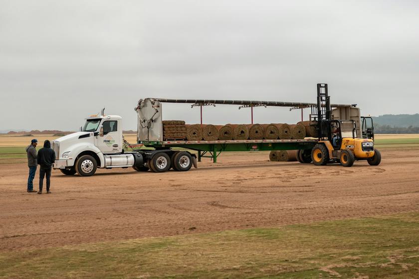 Flatbed trailer being loaded with a forklift